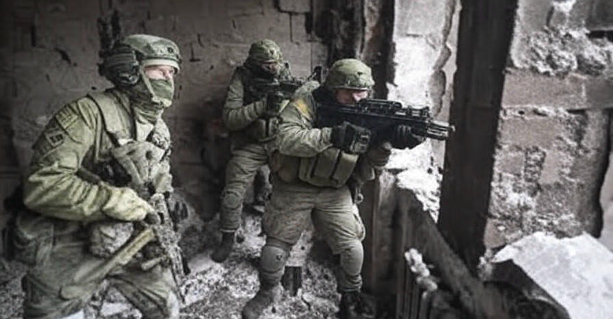 A tense scene from the Ukraine-Russia conflict on June 1, 2025, at 07:45 PM PKT, showing two Ukrainian soldiers in camouflage gear navigating a ruined building near the front line in south-eastern Ukraine. One soldier crouches with a rifle ready, while the other peers cautiously through a shattered window, surrounded by debris and snow-dusted rubble, with a faint outline of a destroyed village visible in the background, reflecting the brutal storm of the ongoing war