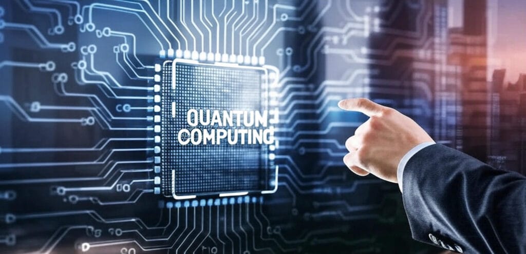 The image depicts a futuristic digital interface featuring a circuit board pattern with glowing blue and white lines and nodes, symbolizing advanced technology. At the center, a highlighted section displays the text "QUANTUM COMPUTING" in bold white letters within a rectangular frame, resembling a microchip or digital display. A hand in a dark suit sleeve, with a finger pointing toward the text, suggests interaction with the interface. The background includes a blurred cityscape with a warm sunset or sunrise, adding a modern and dynamic context to the theme of quantum computing innovation.