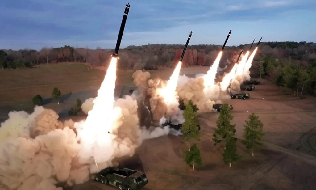 A military parade featuring a large Pakistan missile mounted on a multi-axle transporter erector launcher, with soldiers standing atop, showcasing Pakistan's advanced missile technology during a ceremonial event.