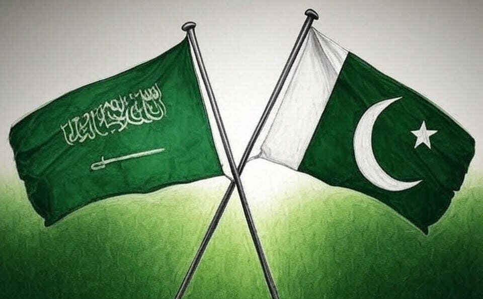 The image depicts two flags crossed at their poles against a light background. The flag on the left is the national flag of Saudi Arabia, featuring a green field with white Arabic script and a white sword emblem. The flag on the right is the national flag of Pakistan, consisting of a white vertical stripe on the left side and a dark green field with a white crescent moon and star on the right.
