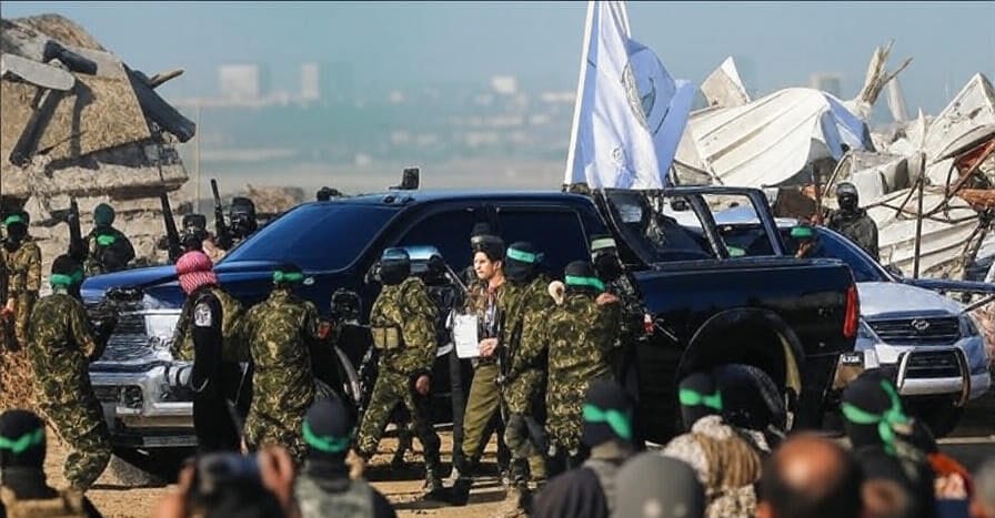 A scene in Gaza on October 14, 2025, depicting Hamas militants standing near a black pickup truck with a white flag, amidst rubble and destroyed buildings, as part of the ceasefire and hostage release process, with onlookers in the background, reflecting the ongoing tensions and humanitarian challenges covered by newsflayer.com.